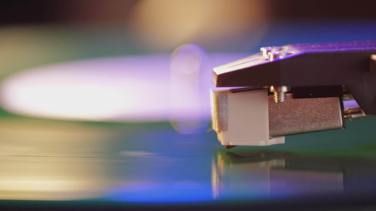 Retro Vinyl record player playing music, close-up macro shot of vintage LP disc old phonograph spinning. Retro music player.