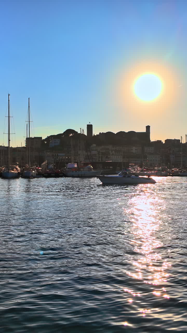 Boat moving in the Port de Cannes, France in daylight. Vertical