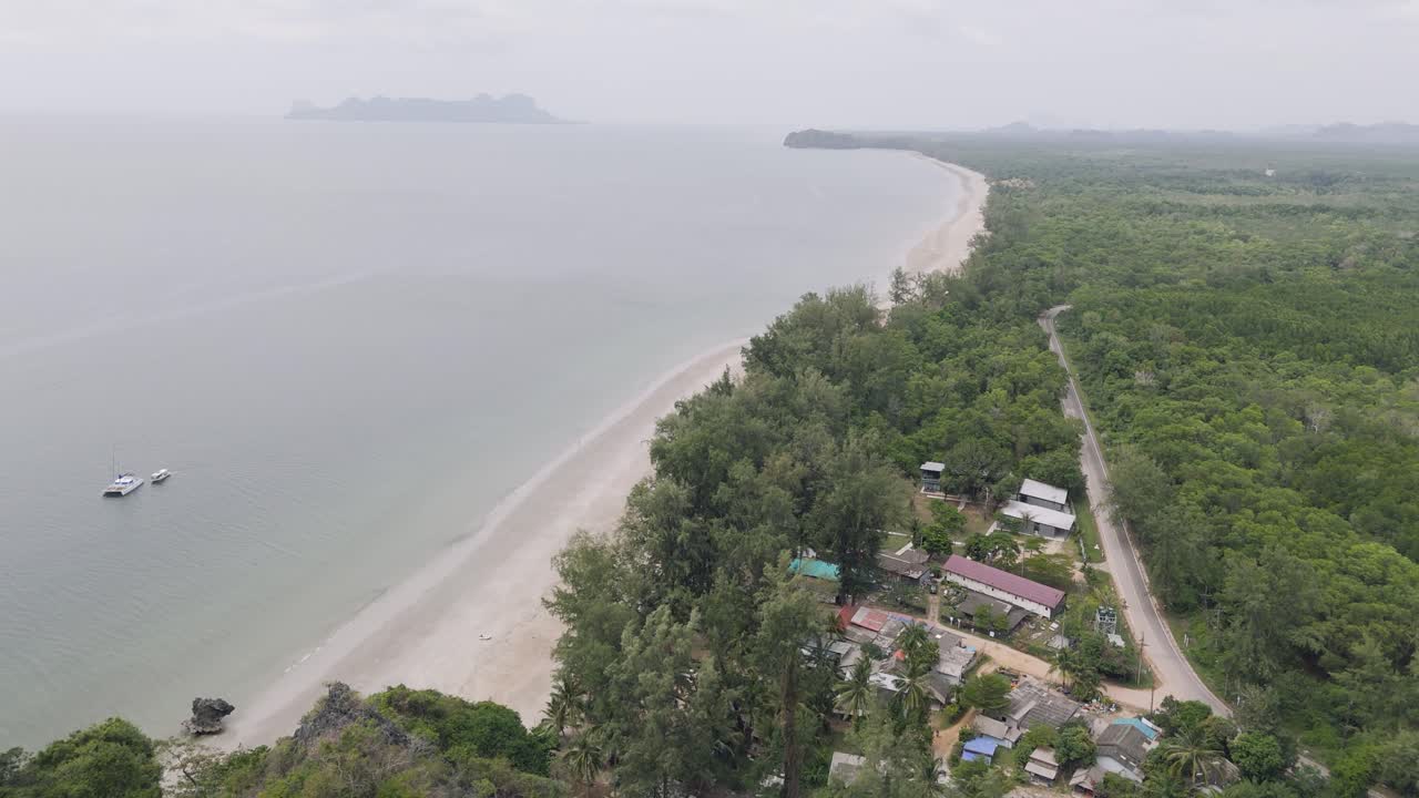 Cinematic fly next to cliff at Had Yao beach in Thailand