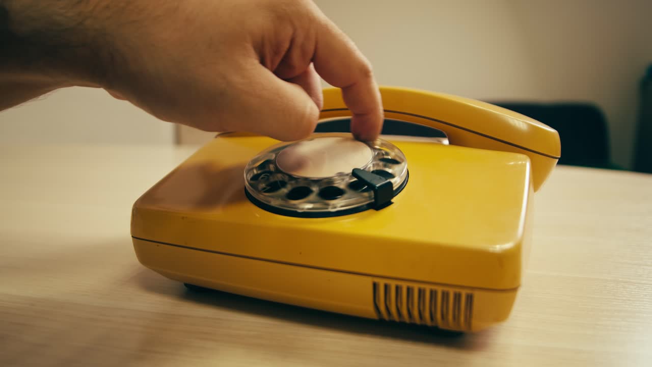 Retro vintage phone, A yellow rotary telephone is displayed on a wooden desk, adding a nostalgic touch