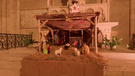 a peaceful nativity scene inside saint-nicolas church in blois, france, glowing warmly