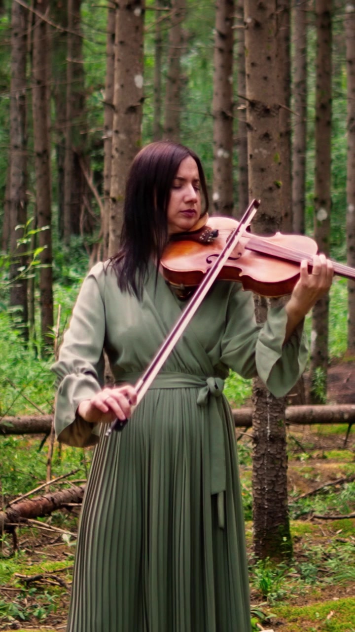 Woman Playing Violin in a Serene Forest Setting