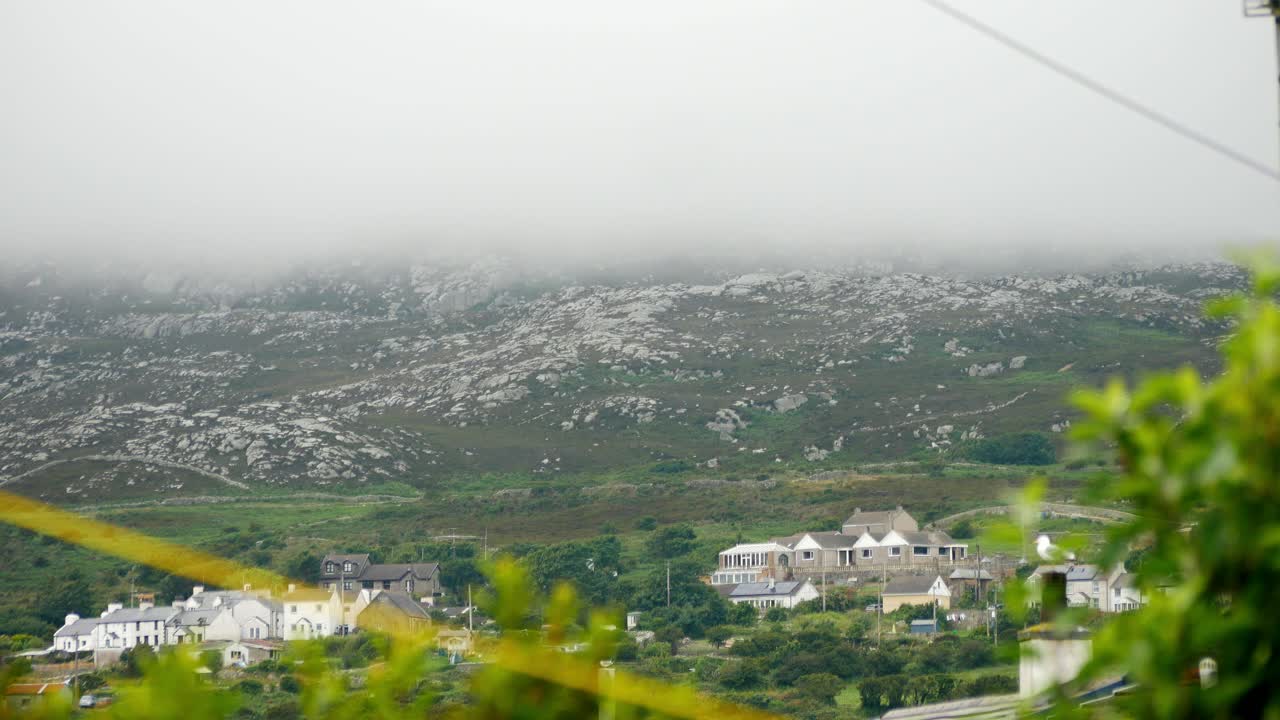 Rolling low clouds across Holyhead mountain properties under rocky Welsh hiking attraction