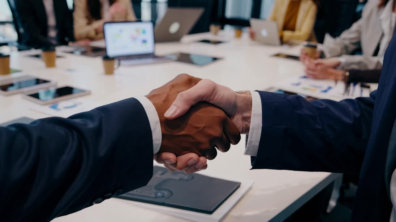 High-angle video of a diverse business team in a modern conference room, engaged in a meeting