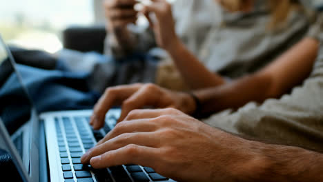 couple using mobile phone and laptop in living room 4k