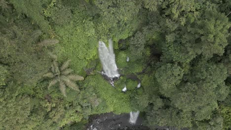 Rising-aerial-of-tall-jungle-waterfall-on-slopes-of-Mt-Rinjani,-Lombok