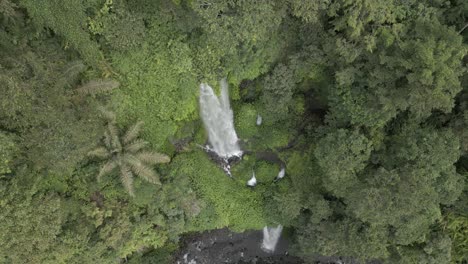 rising aerial of tall jungle waterfall on slopes of mt rinjani, lombok