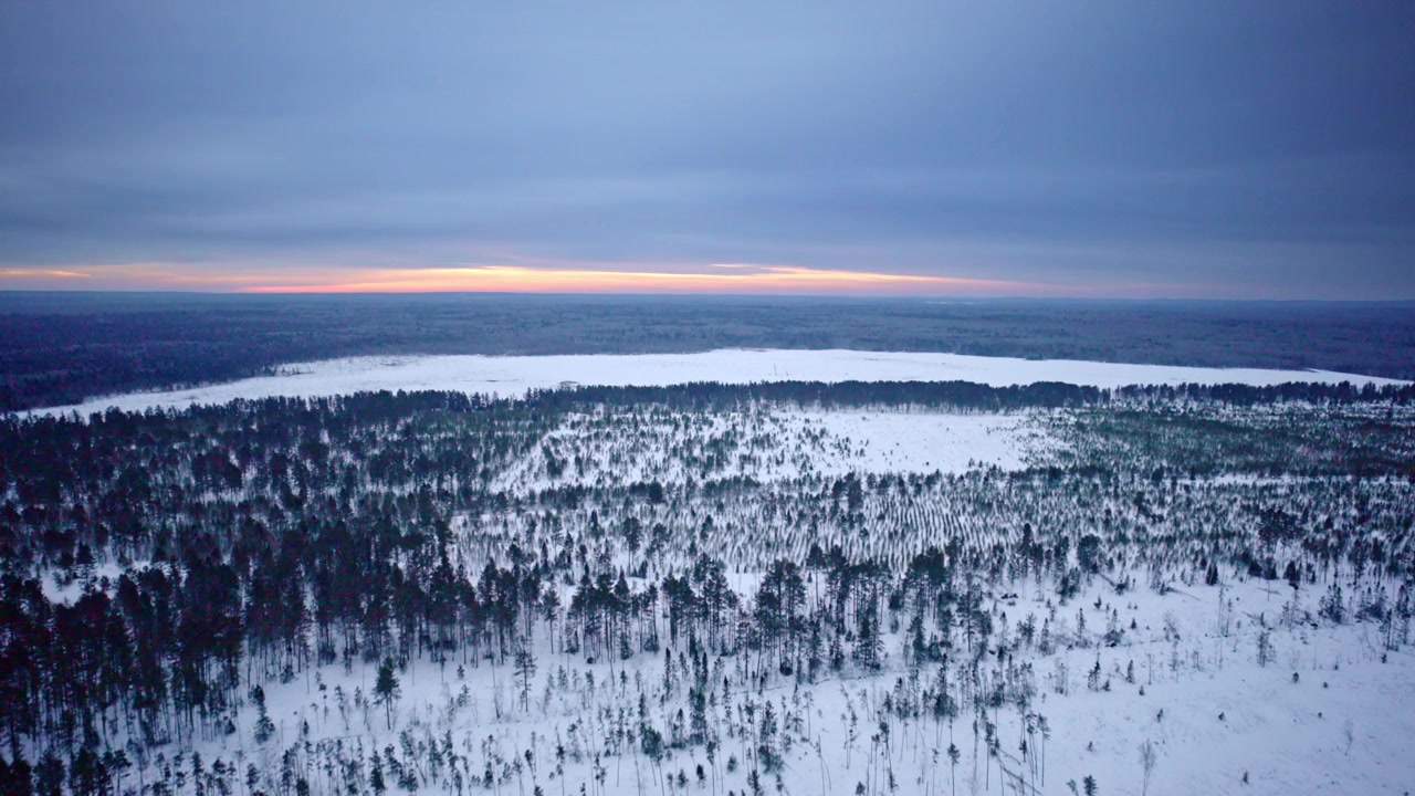 Wide aerial view of lonely US Highway 2 through northern Michigan terrain