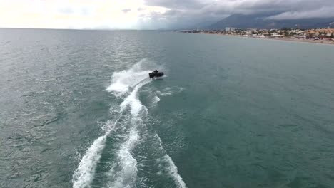 video shows quick standup-jetski racing turns in water, filmed on the south coast of spain, marbella, malaga, spain