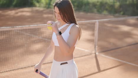 a young woman practicing tennis on an outdoor court with a coach. the coach provides guidance as the player works on her technique, perfecting her strokes in an athletic training session.