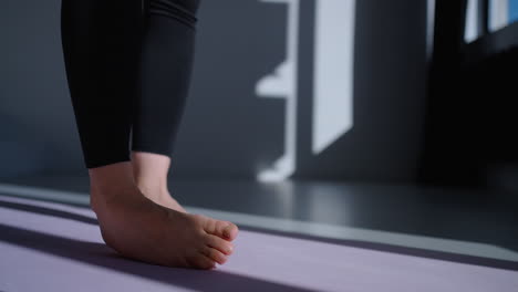 Woman practicing yoga pose on mat