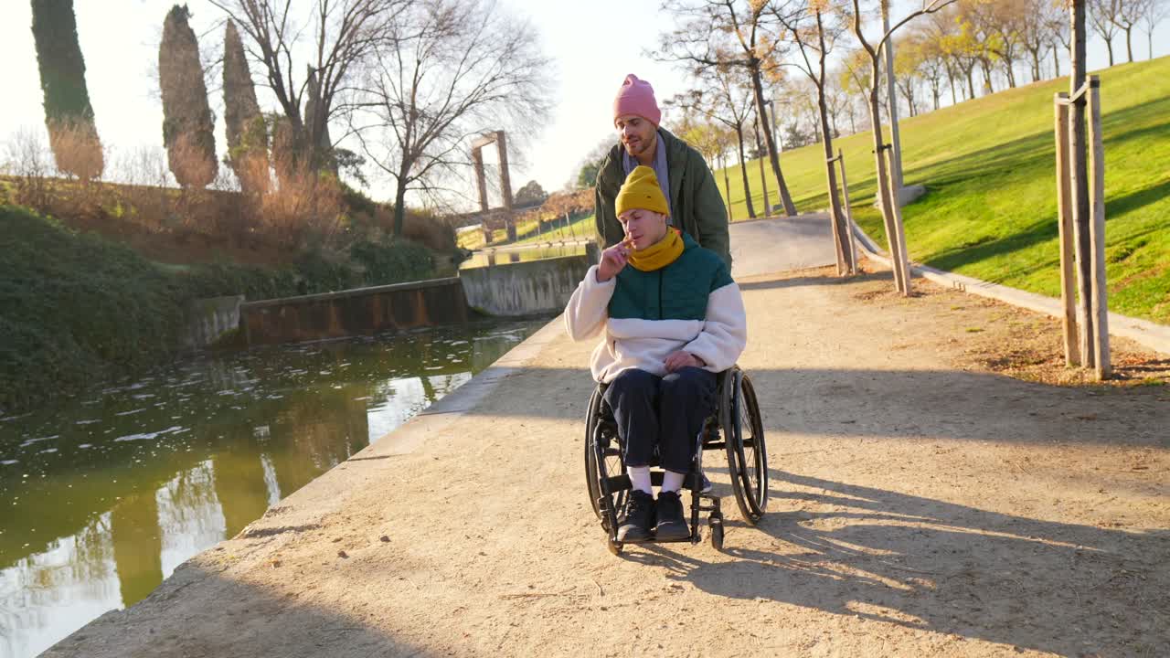 Couple in park with wheelchair