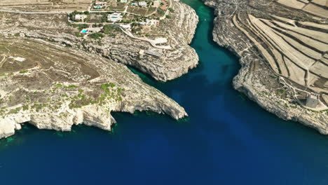 drone footage over mġarr ix-xini beach on the island of gozo in malta