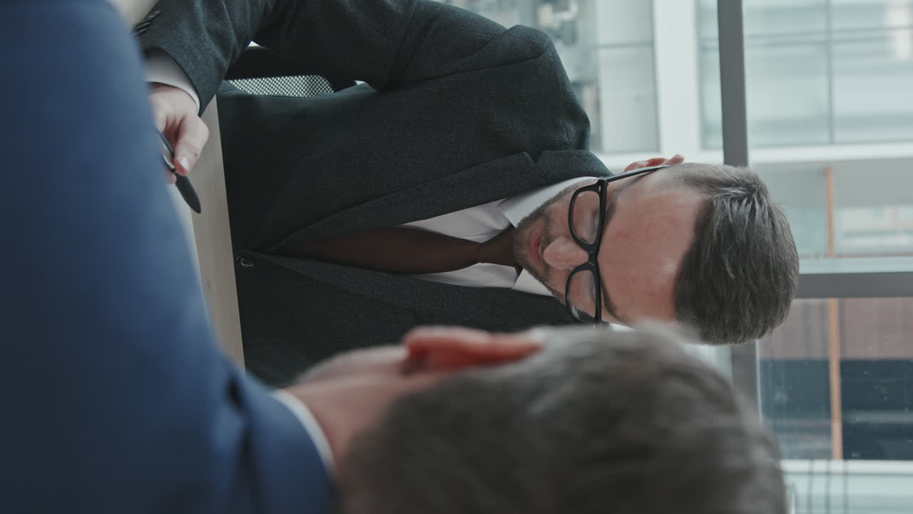 Vertical Shot of Lawyer Consulting Businessman about Legal Documents