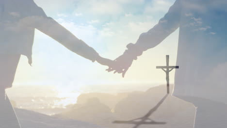 animation of a christian cross over a caucasian couple holding hands