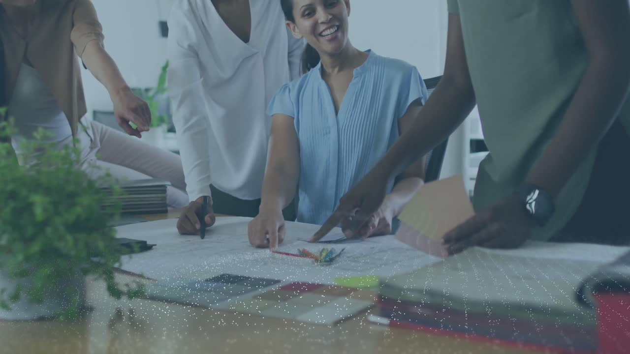 Animation of white spots over diverse business people talking in office