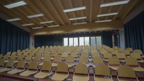 circular shot of empty room hall with chairs and suspended lights