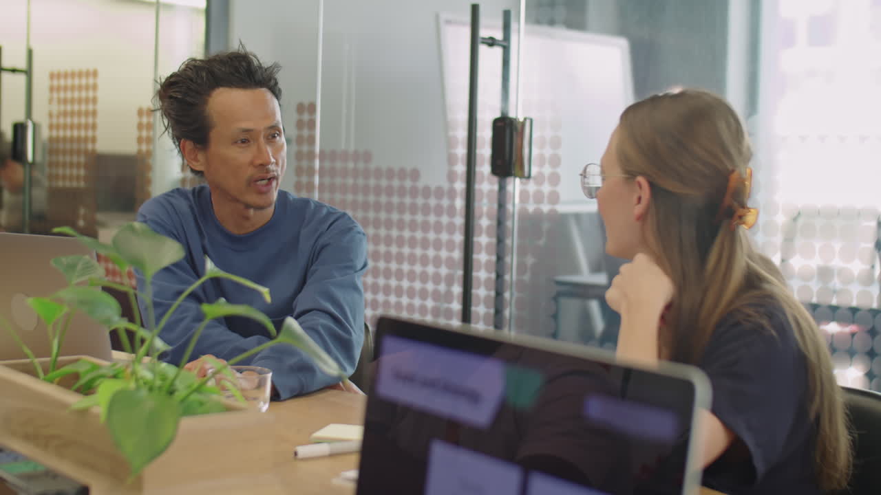 Cheerful Colleagues Talking in Office Meeting Room
