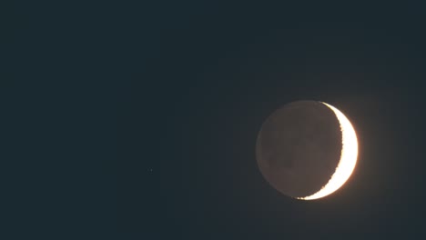 the shaded moon in the clear night sky