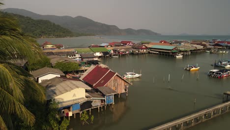 fast aerial pan to the right of the bang bao fishing pier in koh chang, thailand