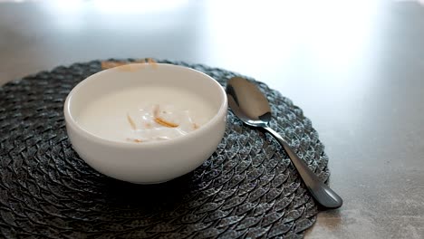 breakfast with whole wheat cereal and corn with plum falling into the bowl