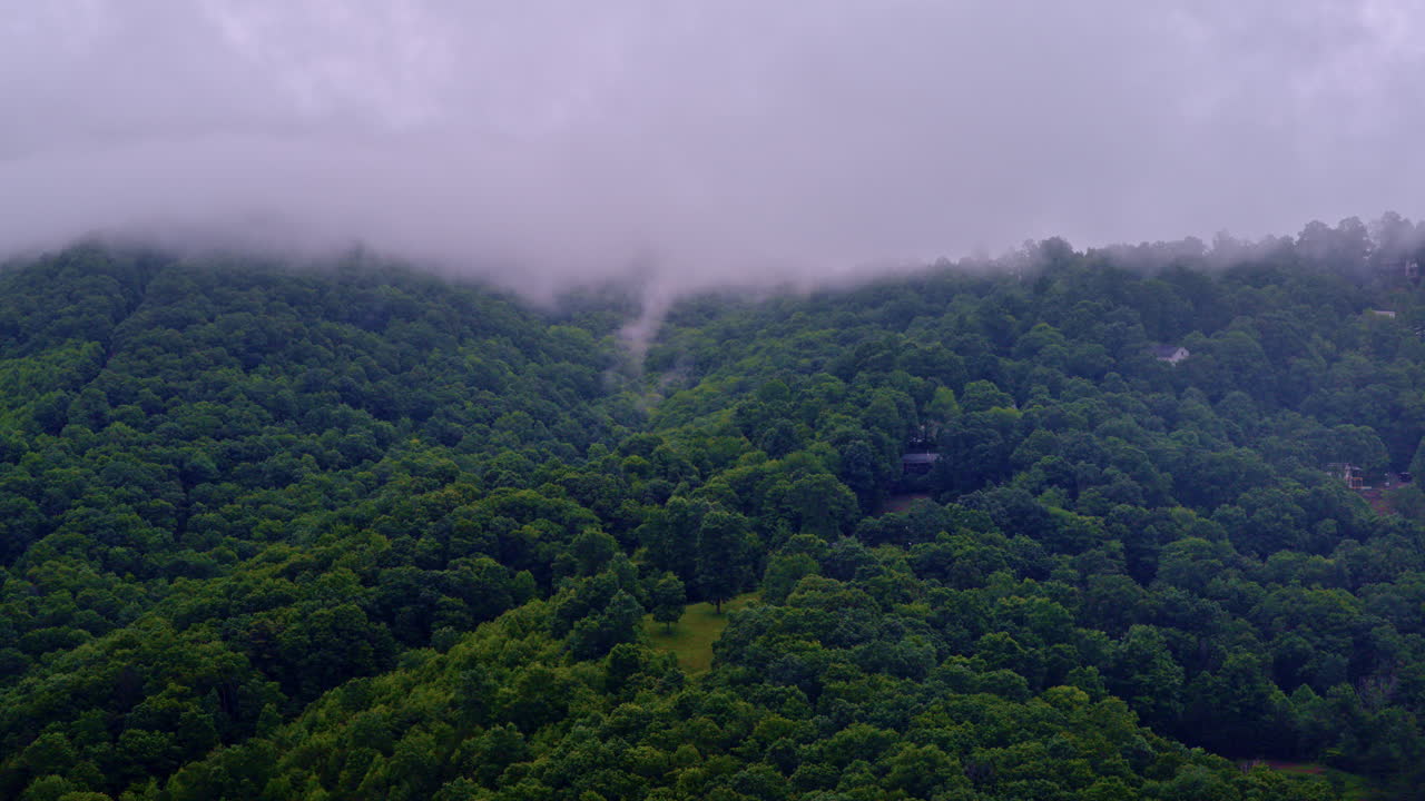 Cinematic flyover moving across a haze-bathed valley in the Smokies