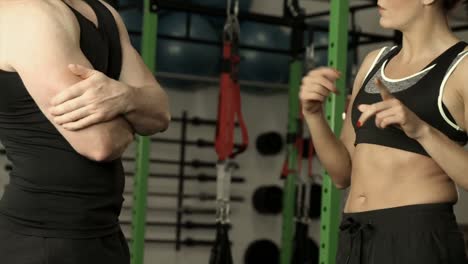 mujer en forma discutiendo con un entrenador personal