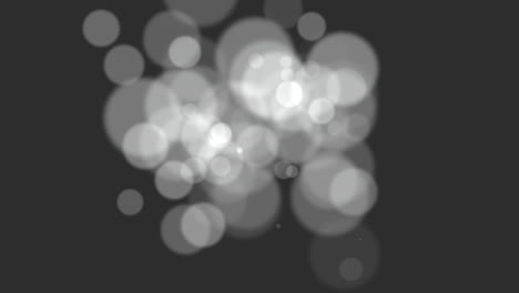 movimiento brillos blancos y bokeh redondo sobre fondo negro