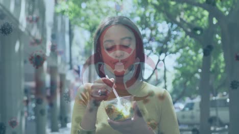 Biohazard-symbol-against-african-american-woman-with-lowered-face-mask-having-a-snack-outdoors