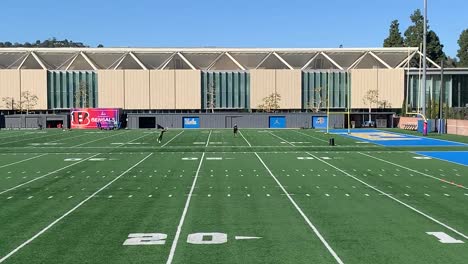 football-field-with-players-practicing