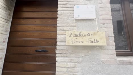 humorous writing on house door for grape harvest festival of medieval penna in teverina town in italy