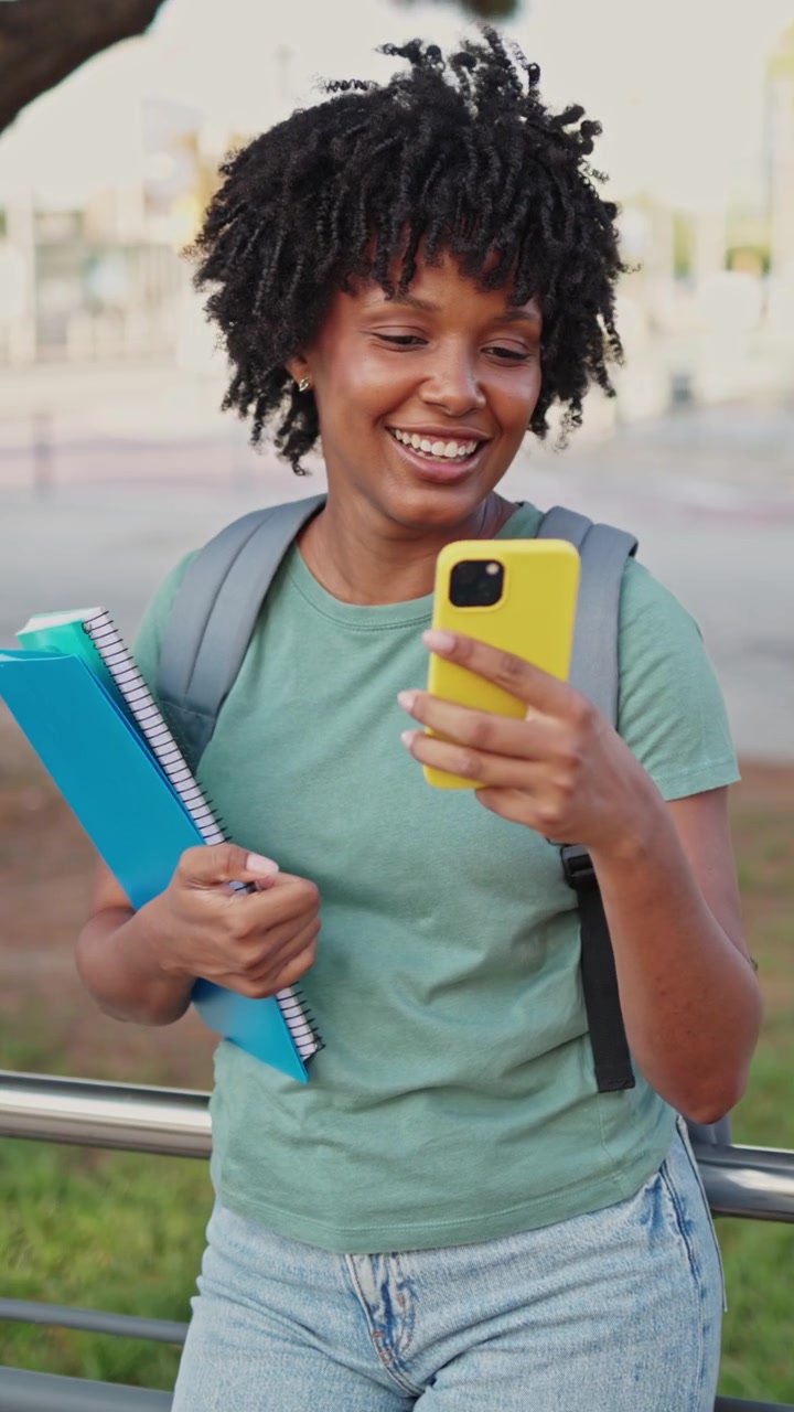 Young African American Woman Smiling and Using Smartphone Outdoors