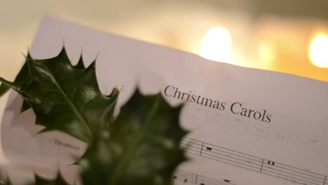 Christmas-Carol-Music-Sheet-with-Candles-and-Holly