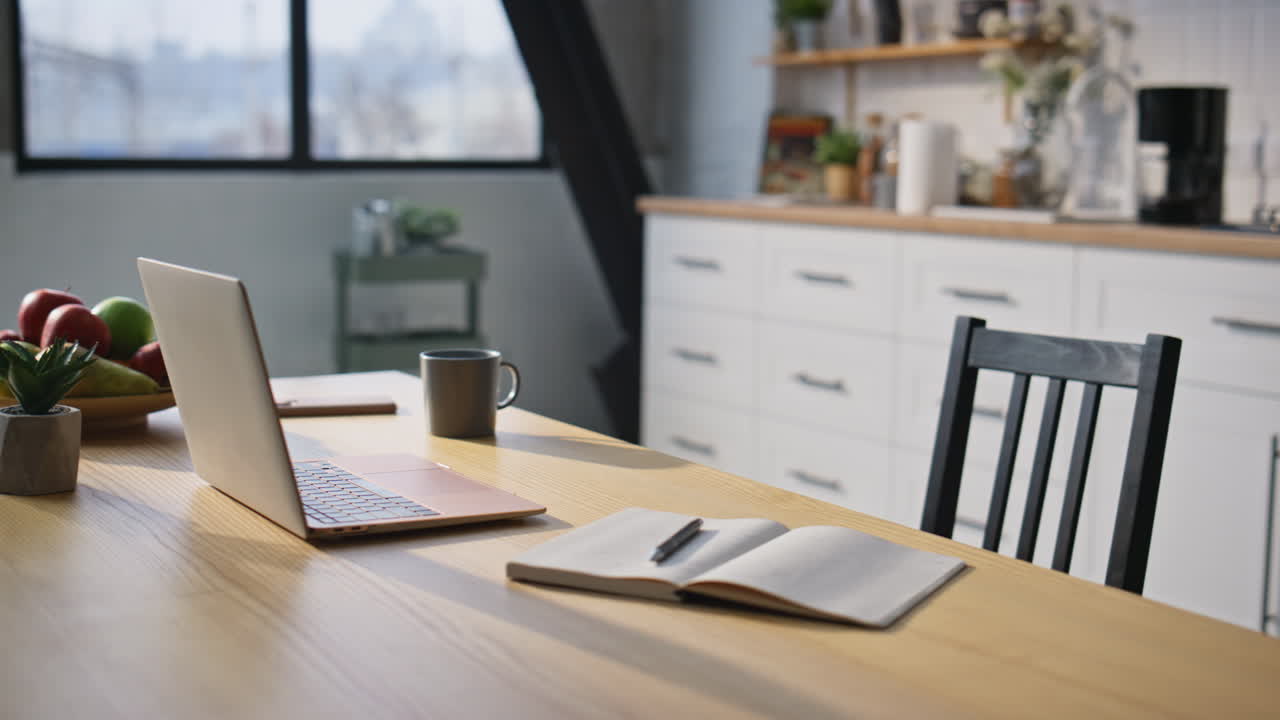 Organized home workspace laptop and notebook in domestic office closeup