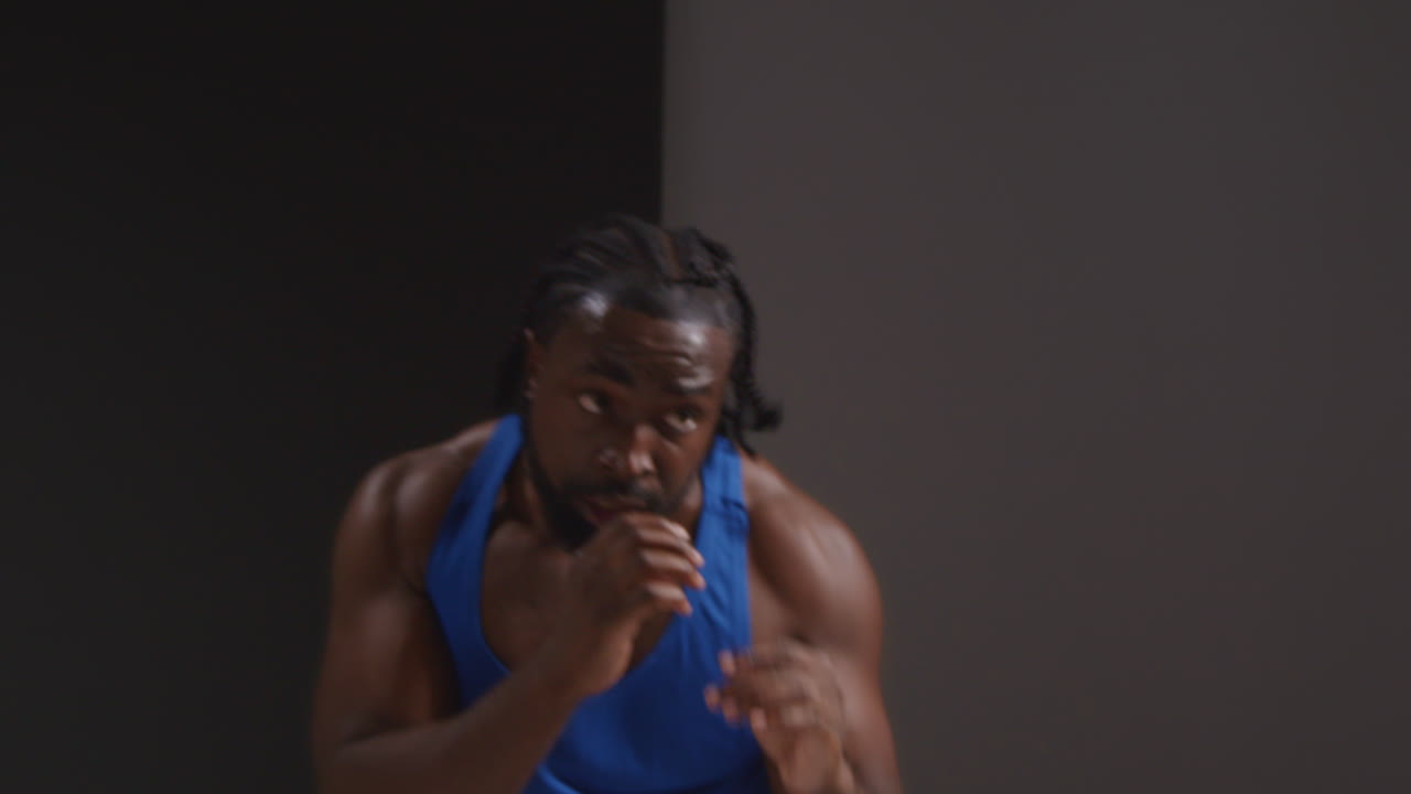 Studio Shot Of Male Boxer Training In Gym Sparring And Sweating Warming Up Preparing For Fight 2