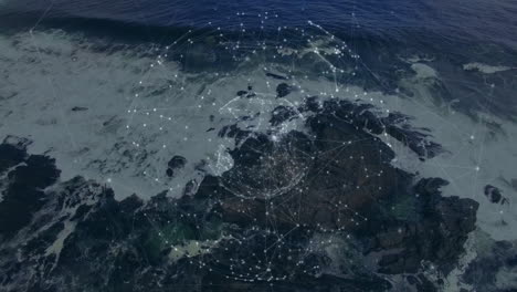 network of connections and data processing animation over rocky ocean shoreline