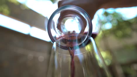 pouring wine from a decanter into a glass