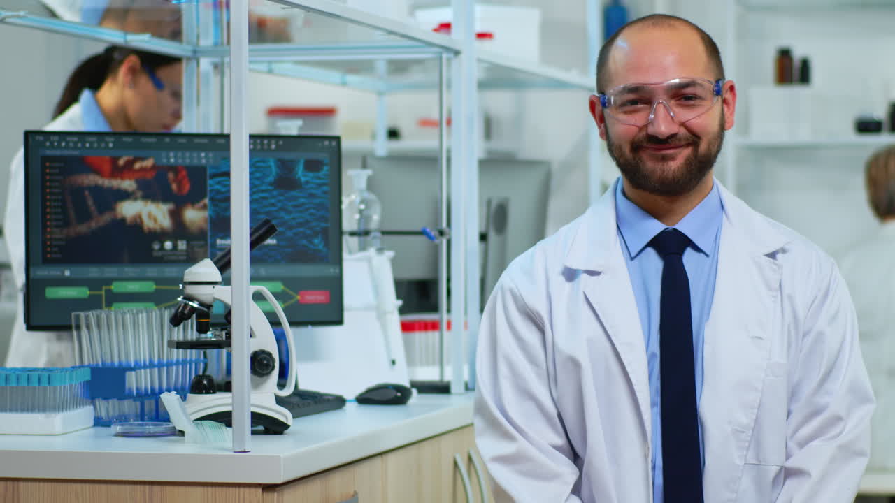 Experienced man scientist looking at camera smiling