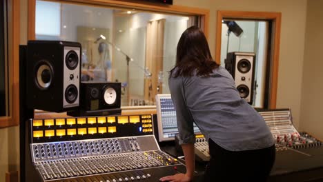 female audio engineer using sound mixer