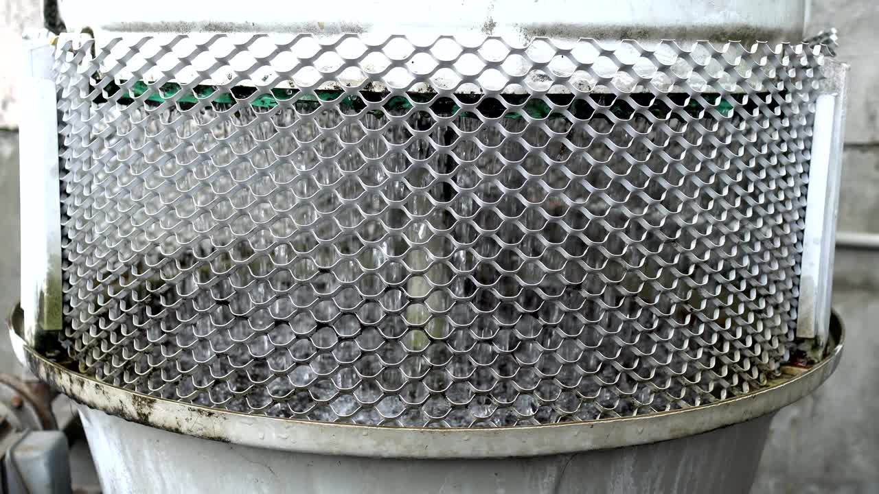 3 phase induction motor. The function is to drain or pump water. The exterior is old and rusty. Close up.