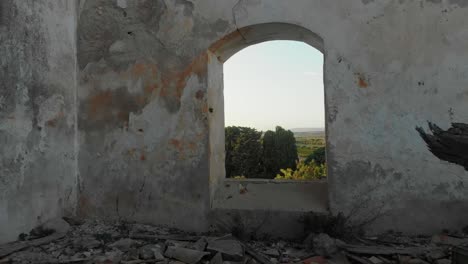 Flying-through-old-window-of-abandoned-farm-at-Sicily-Italy,-aerial