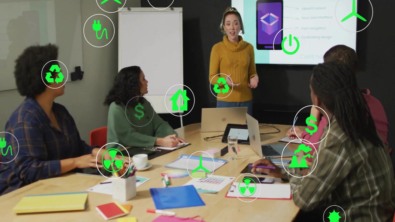 Presenter presenting green energy slides while colleagues taking notes and icons moving over table