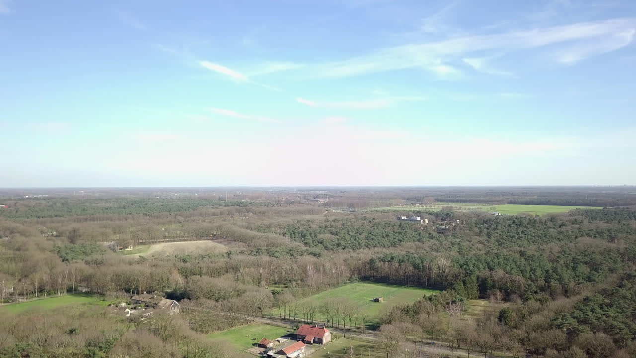 Aerial View of a Rural Landscape with Farmhouse and Forest