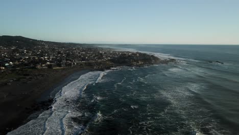 panoramic aerial view of the beach of pichilemu with a strong swell at sunset