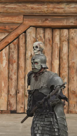 medieval knight walks down rainy street in ancient village with log buildings. dark warrior in armor looks around and moves cautiously wary of ambush