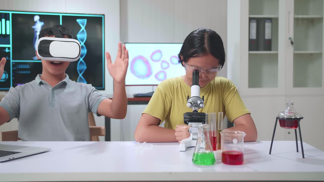 Young Asian Boy And Girl Learning Science Experiment In Laboratory At Classroom. Study With Vr Headset And A Microscope