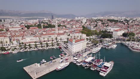 Aerial:-Croatia-Split's-harbor-scene-with-moored-boats,-a-picturesque-pier