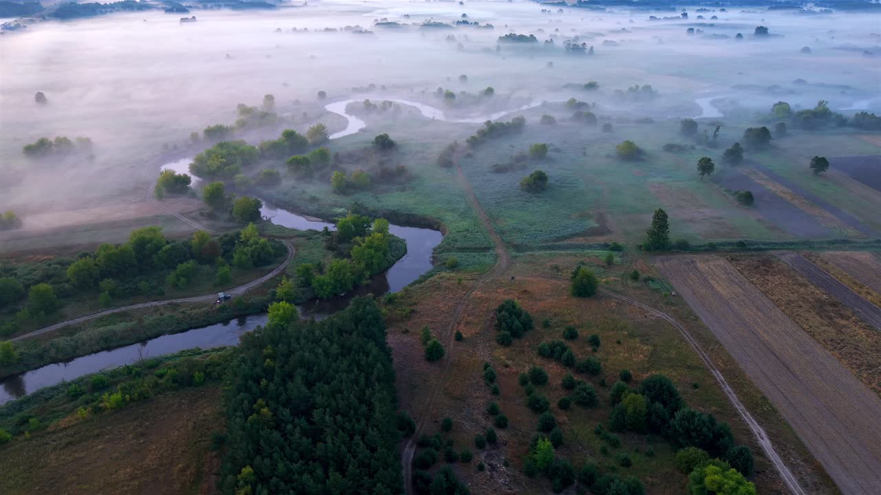 Aerial view of Nida river meanders in morning fog during sunrise