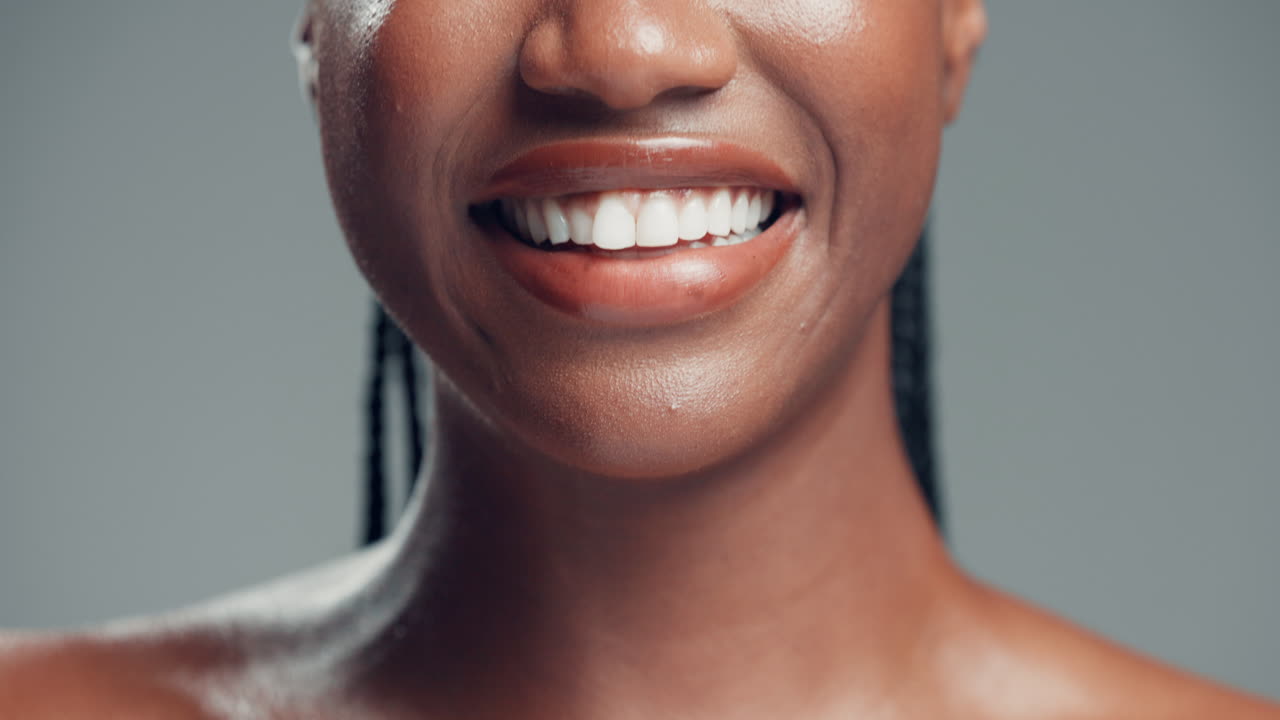Woman Brushing Teeth with Toothpaste