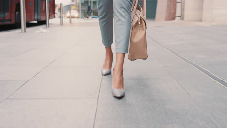 beautiful mixed race business woman's feet walking through city